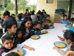 Children enjoying a welcome meal