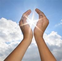 Healing hands raised to sky